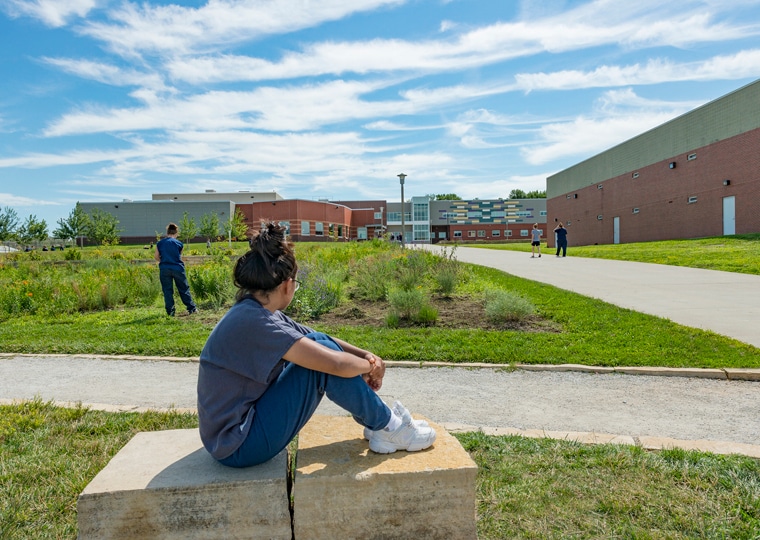 A woman sits in the garden at the Iowa Correctional Institution for Women