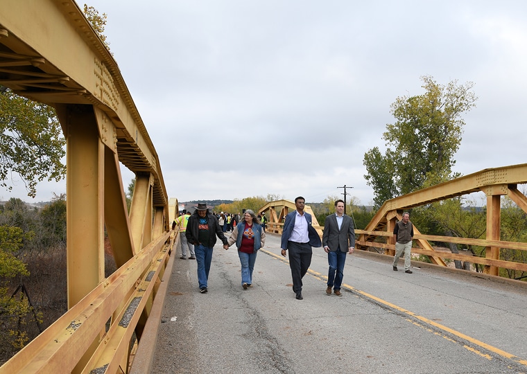 People walk across the Route 66 bridge