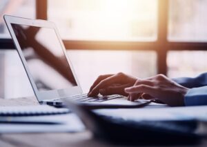 person typing on laptop