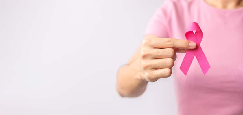 woman holding pink ribbon