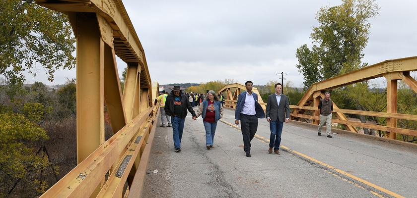 People walk across the Route 66 bridge