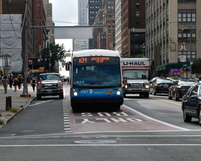 A Select Bus rides across 34th Street.
