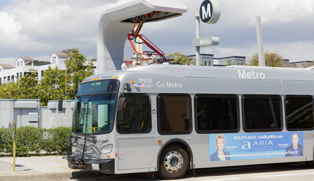 An LA Metro bus charges at a stop