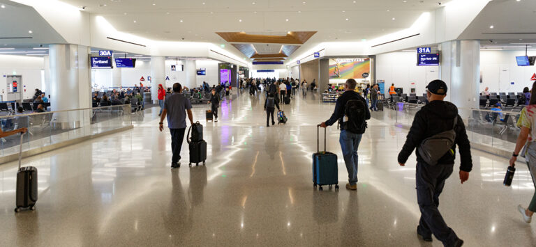 Travelers walk through Delta Airlines' terminal at LAX