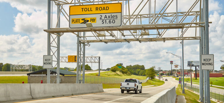 A truck drives through the toll plaza at the reconstructed Elm Street Interchange.