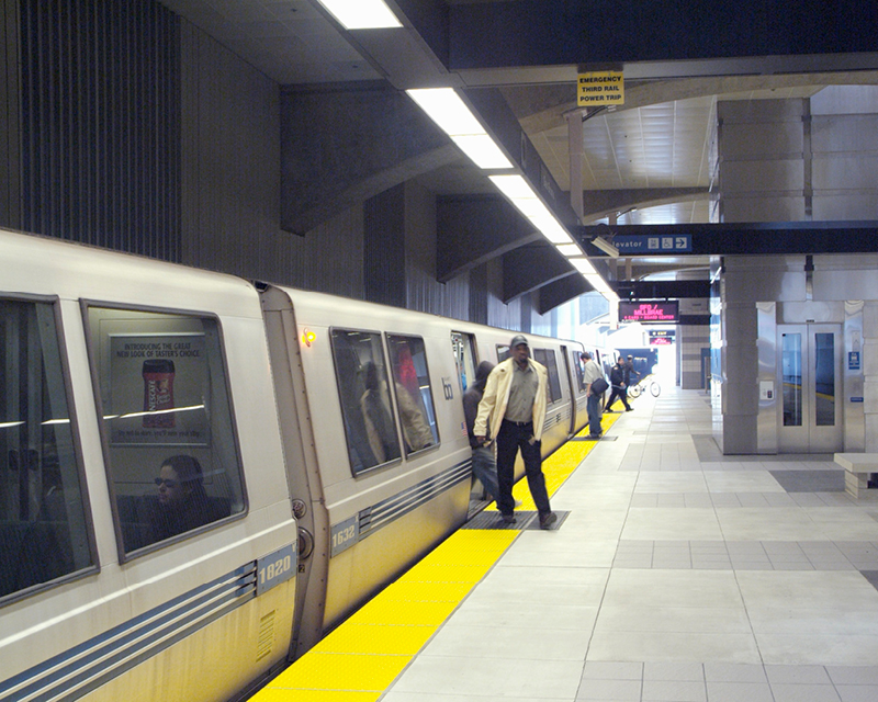 Passengers move through a BART station.