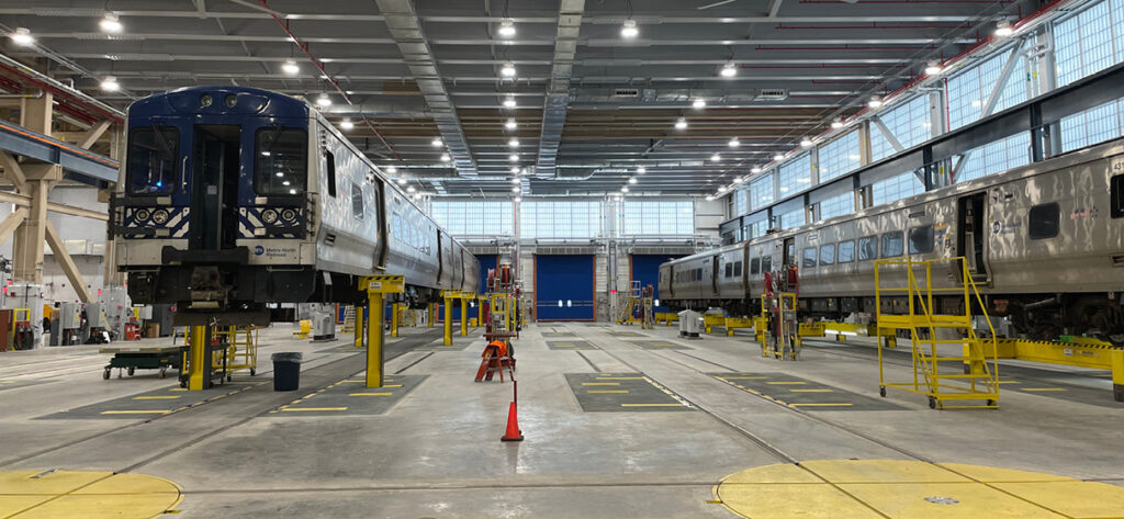 Two Metro-North Railroad vehicles being serviced inside of recently updated Harmon Shop