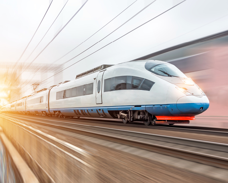 A high-speed train speeds down the tracks.