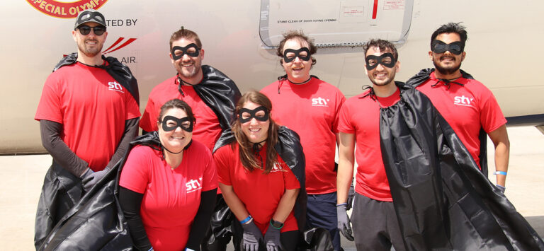 STV's North Carolina team in superhero attire attending the Special Olympics of North Carolina's Plane Pull competition at Raleigh-Durham International Airport