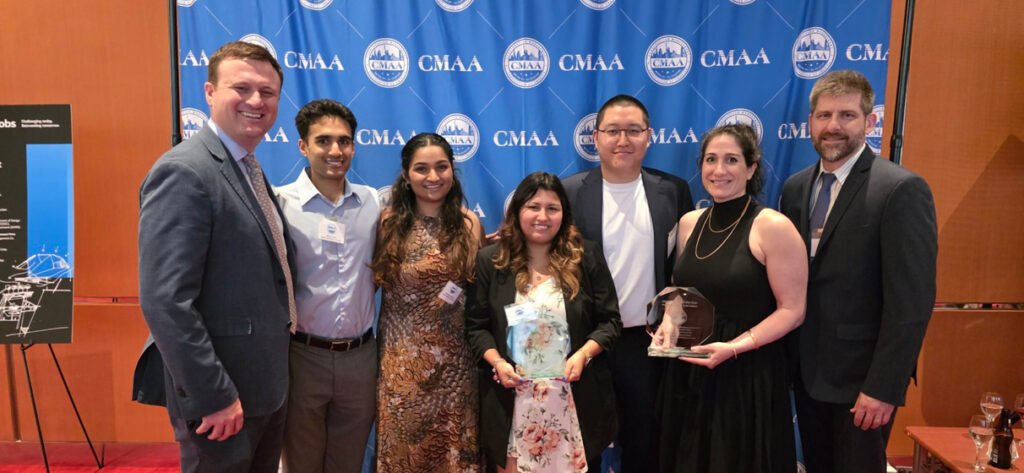 A group photo of seven people shows STV’s project manager for Metropolitan Hospital, Andrew Eckl (far right) who is pictured with the construction management team from Gilbane at the awards ceremony in June 2025