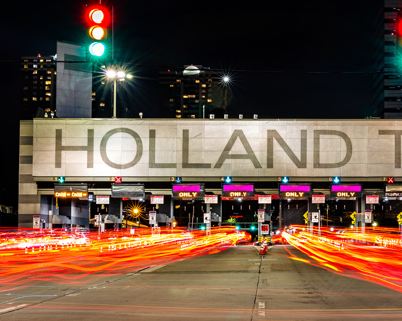 Cars driving through the toll plaza at the NJ entrance to the Holland Tunnel.