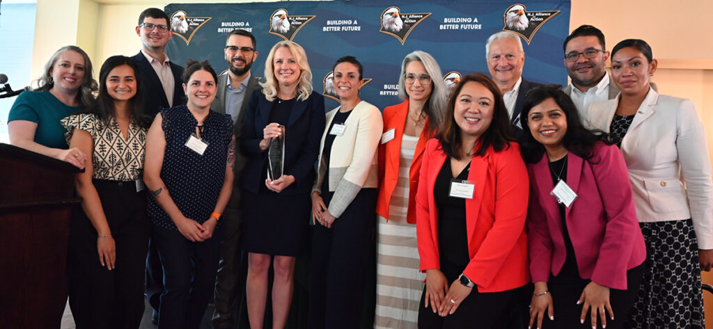 Kim Vierheilig in a group shot surrounded by her STV colleagues at the NJ Alliance for Action award ceremony.