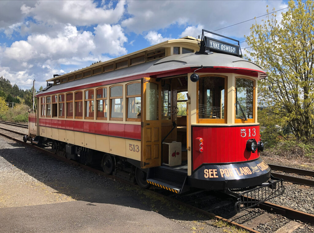 Side view of the Willamette Shore Trolley, a vintage trolley car, while on the tracks between Lake Oswego and Portland.
