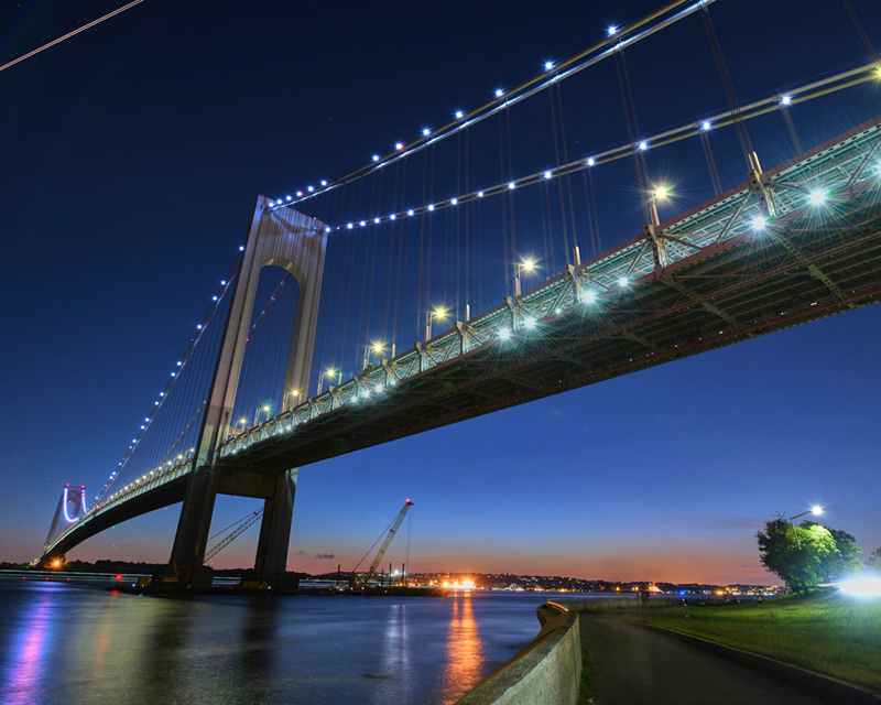 Night view of the Verrazzano-Narrows Bridge from the walkway below.