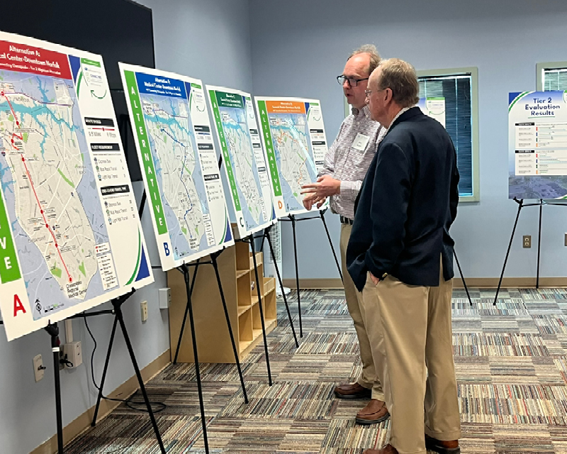 STV’s Eric Nelson (left) speaks with an attendee during a Connecting Chesapeake public meeting in January 2025.