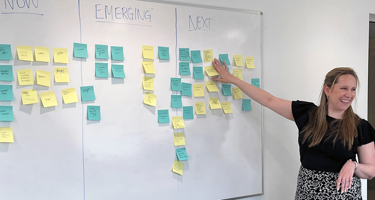 The Stakeholder Engagement & Communications Outreach team conducting a strategy meeting with sticky notes on a white board.