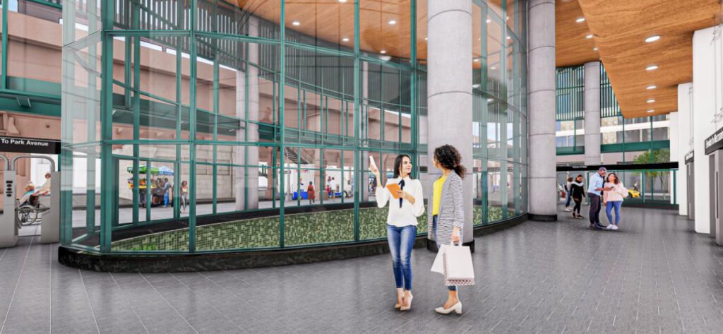 Interior rendering of Second Avenue Subway station showing two women having a conversation in front of a glass atrium, along with other commuters in the station.