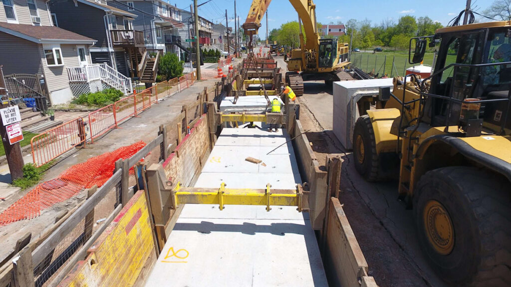 Construction screws install updated storm sewer infrastructure to improve capacity in the New Dorp Beach neighborhood of Staten Island.