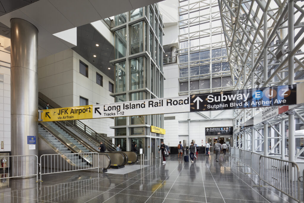 Interior view of Jamaica Station depicting wayfinding signage for the Long Island Rail Road, New York City Subway system and JFK AirTrain connection