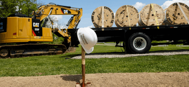 Shovel in the ground with a hard hat on top taken during the groundbreaking ceremony for a new Service Wire facility in West Virginia.