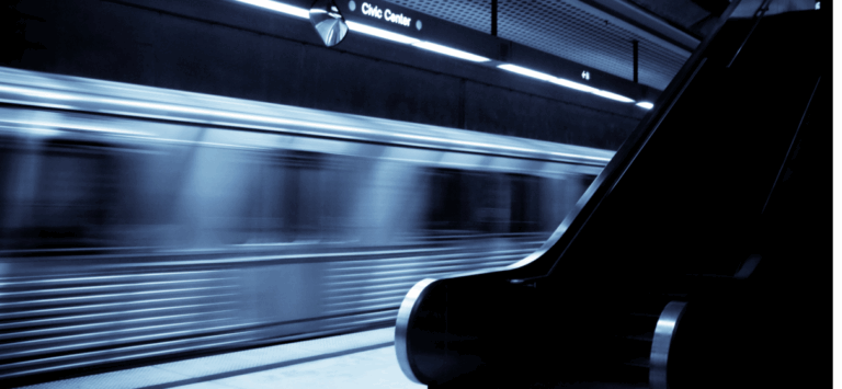 Blurred Los Angeles Metro subway train arriving at station.