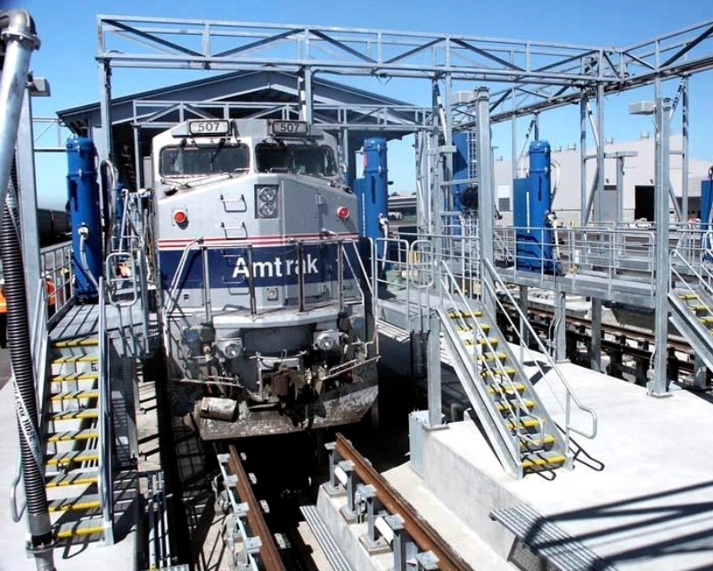 Amtrak locomotive in car washing area at West Oakland Maintenance Facility.