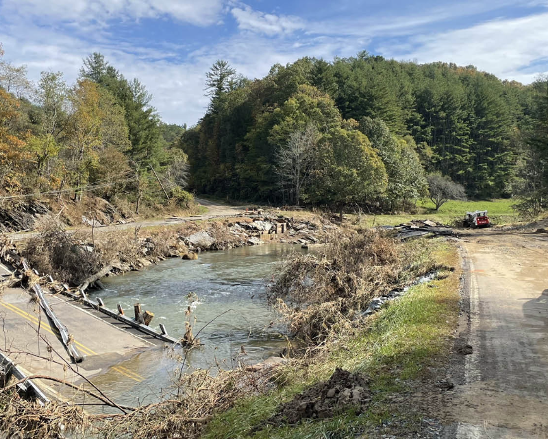 An STV truck sits on the side of a North Carolina road that was damaged during Hurricane Helene.