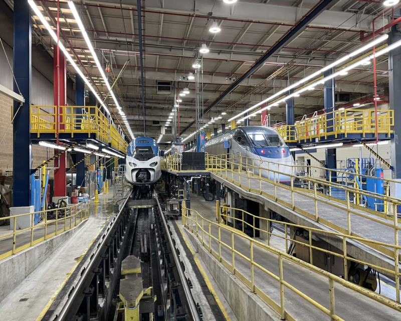 Interior view of Amtrak's Ivy City maintenance facility in Washington, D.C., with two Acela trains in service bays.
