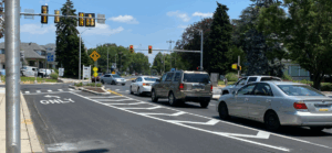 Roadway intersection with traffic signals and cars