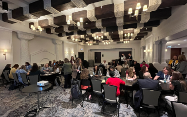 People seated in banquet hall at outreach event