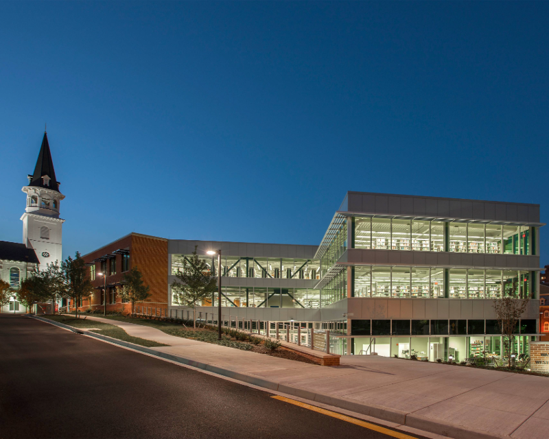 Night view of exterior of Washington Country Central Library, observing the book stacks.
