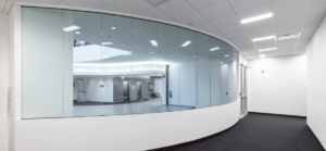 White hallway with reflective glass and grey carpet