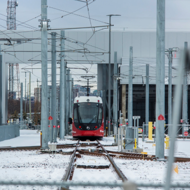Rail car driving head-on on snowy tracks