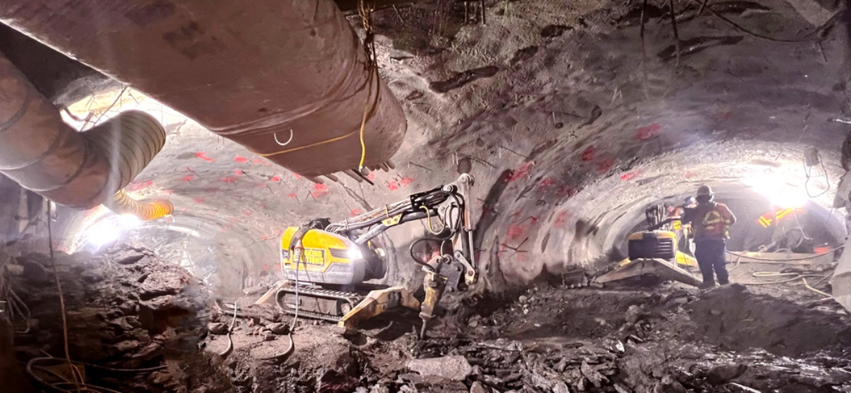 Underground tunnel under construction with excavator