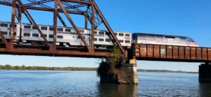 A Virginia Railway Express commuter train passes over the Long Bridge connecting Washington, D.C., to Virginia.