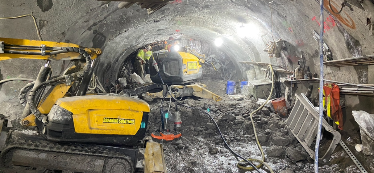 Underground tunnel under construction with excavator