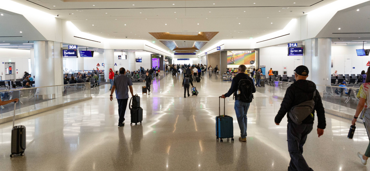 interior of LAX featuring seating and passengers with luggage