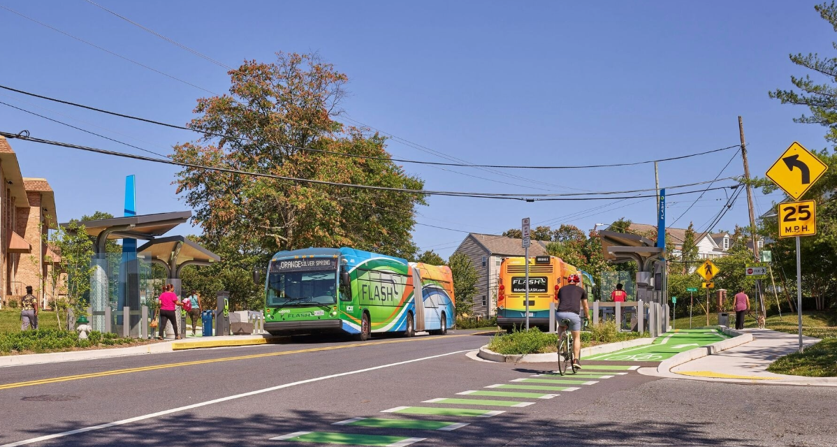 A cyclist uses the bike lane in front of a FLASH BRT vehicle in Maryland.