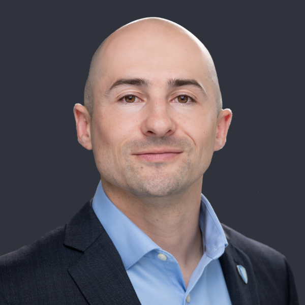headshot of man with blue dress shirt
