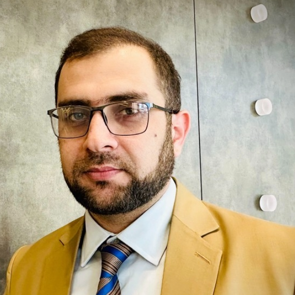 headhsot of many with glasses and beard