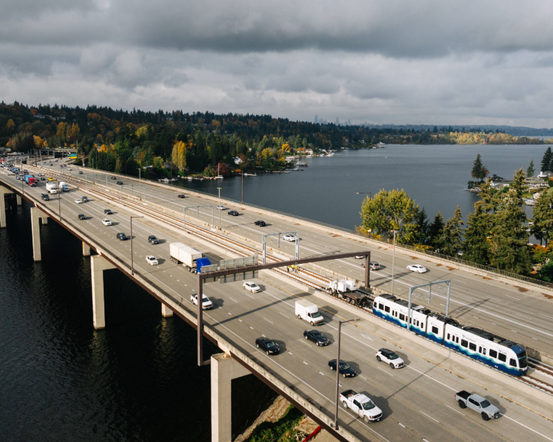 Cars and light rail transit share right-of-way along the floating bridge for Sound Transit Crosslake Connection.