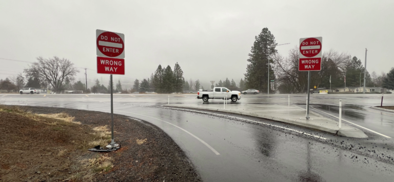 Rainy highway ramp with wrong way driving signs