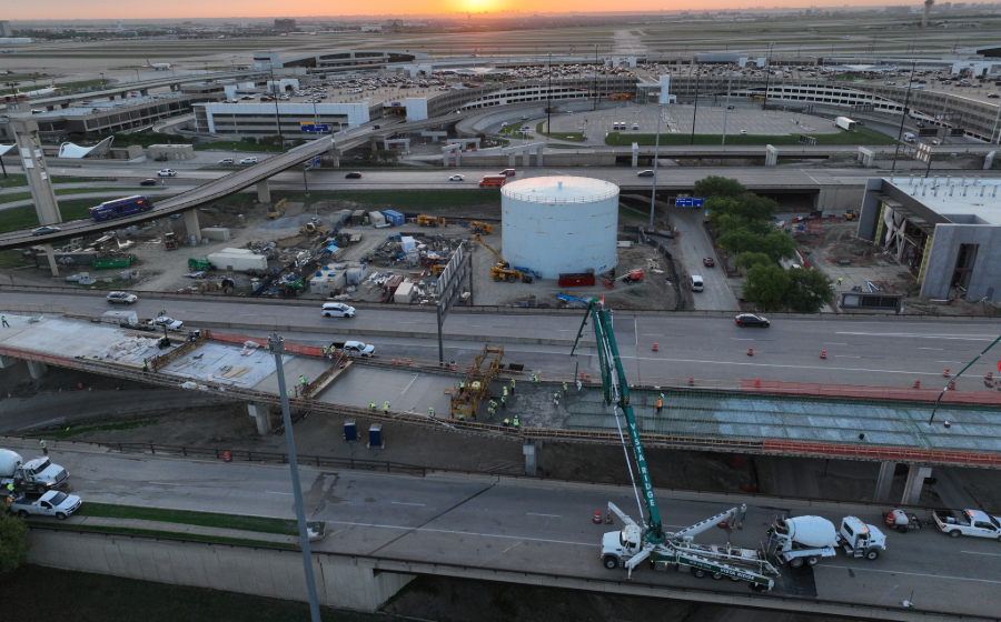 Construction crew setting up equipment at dusk as part of the construction of the International Parkway at DFW Airport.