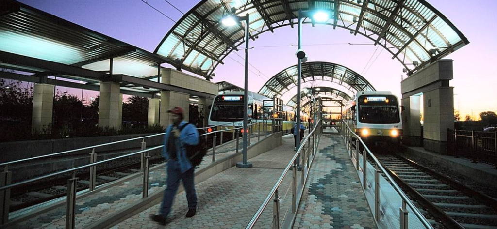 DART station in Dallas, TX with two trains and passengers