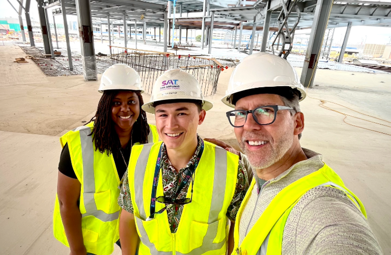 STV's San Antonio airport CM/PM team in front of the terminal's frame under construction.