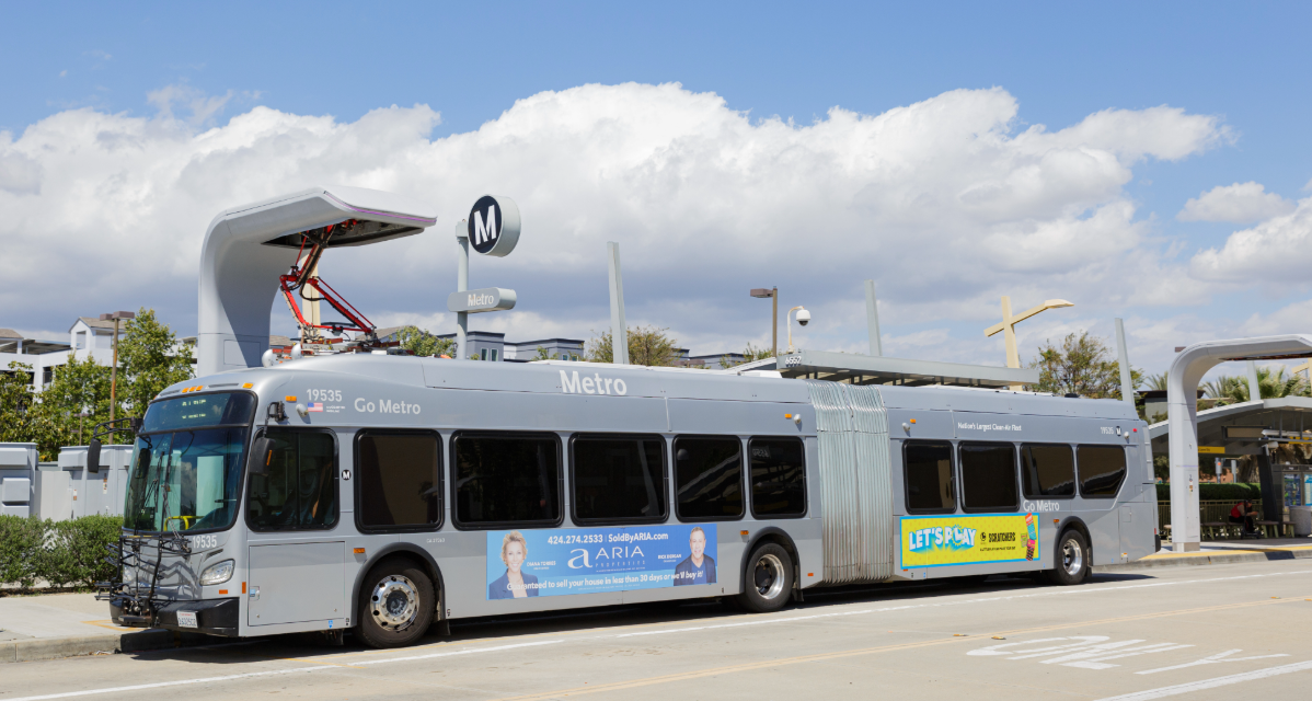 An electric Los Angeles Metro bus charging at a bus depot in California.