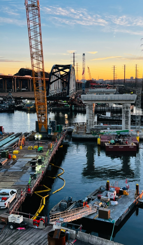Installation of the east-side arch via barges in the Hackensack River for Portal North Bridge.