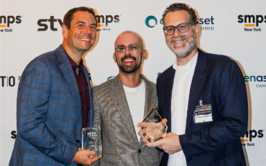 STV Communications team members celebrate with trophies from SMPS-NY marketing awards.