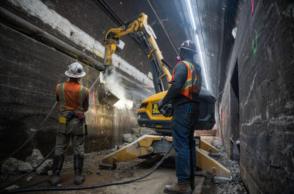 Construction crews excavate inside the East River Tunnel in New York.