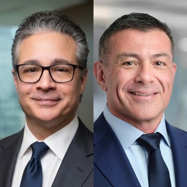 Headshots of two men one with glasses and dark suit and tie (left) and one with blue suit and tie (right)